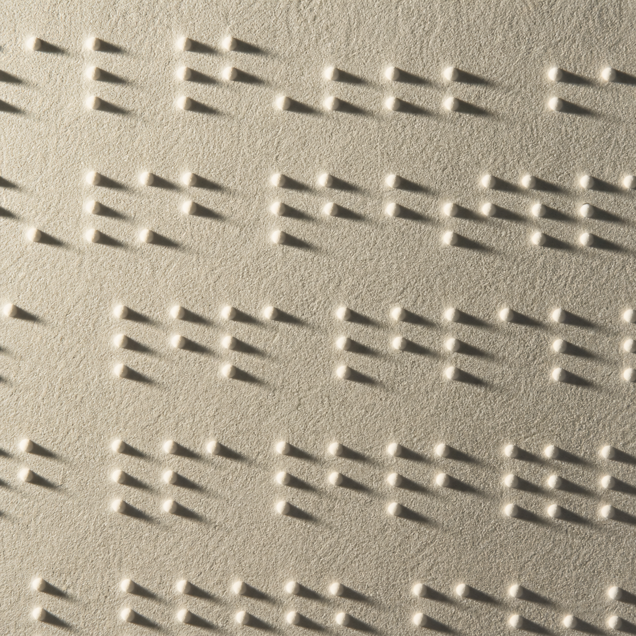 Close-up of embossed Braille dots on premium paper
